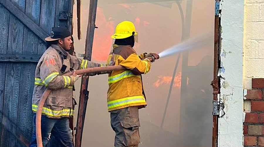 Firefighter with hose Arturo Fuente warehouse fire