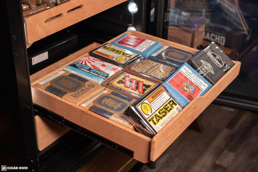 Newair NCH1K5BK00 1500 count humidor shelf filled with cigar bundles