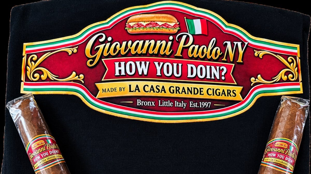Two Giovanni Paolo How You Doin! cigars by La Casa Grande on a black shirt with the band artwork